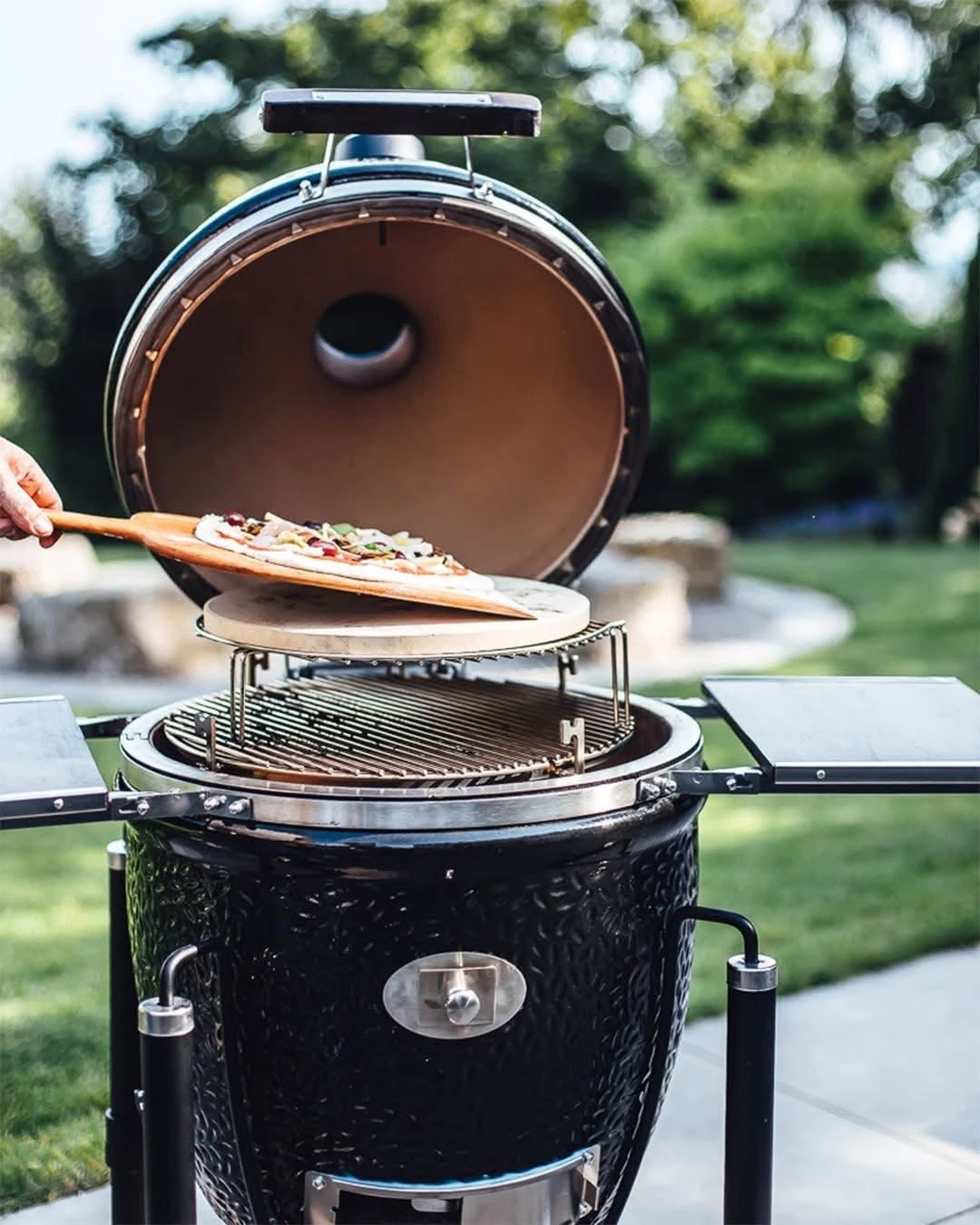Pizza going into a Monolith kamado grill